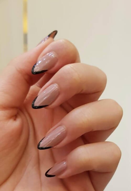 Neutral-colored nails with black tips